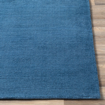 Livabliss Mystique M-330 Dark blue hand-loomed wool area rug with high-pile texture on wood floor, crafted in India for contemporary style and comfort.
