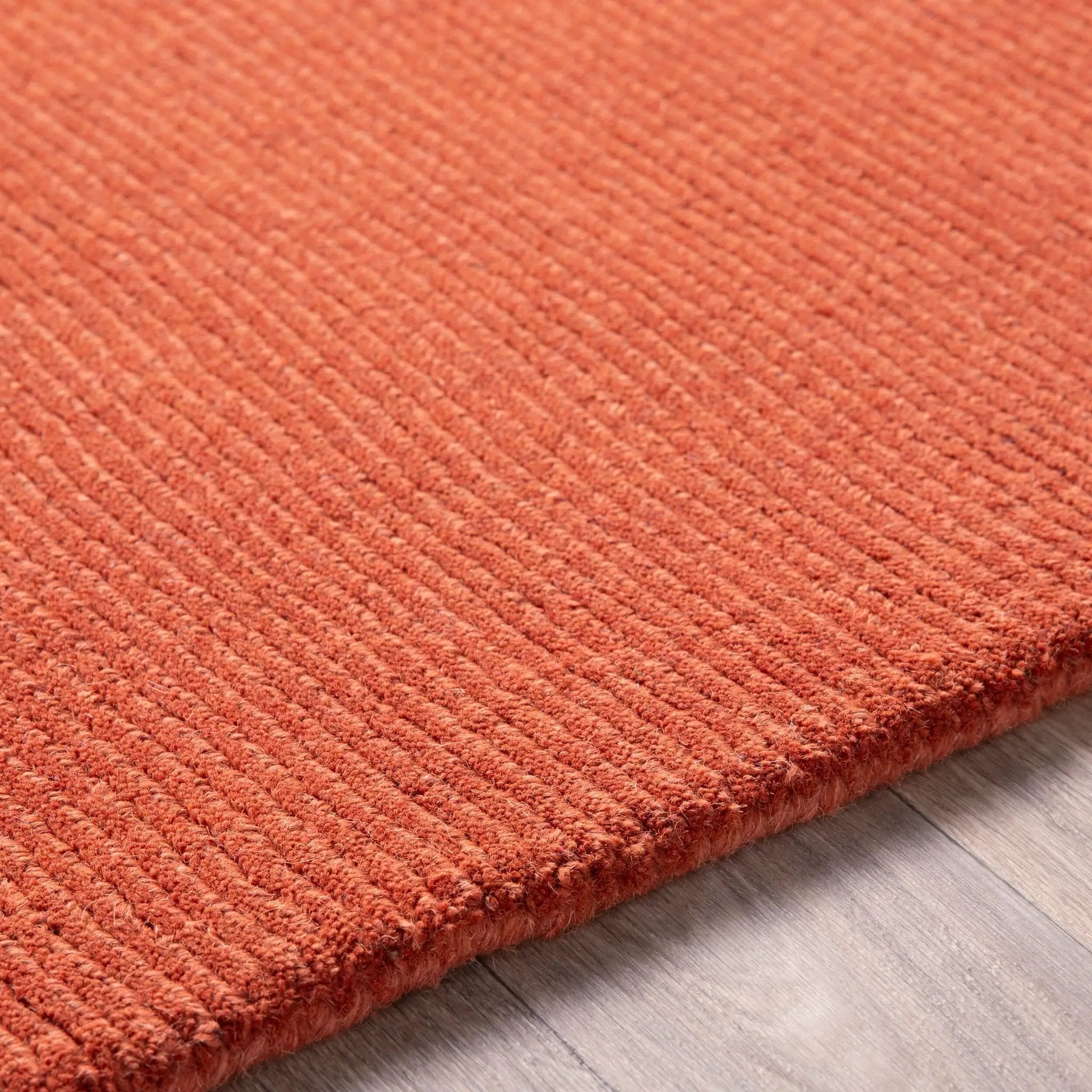 Livabliss Mystique M-332 Burnt-orange hand-crafted wool area rug featuring a structured high/low pile weave for added texture and modern warmth in living spaces.