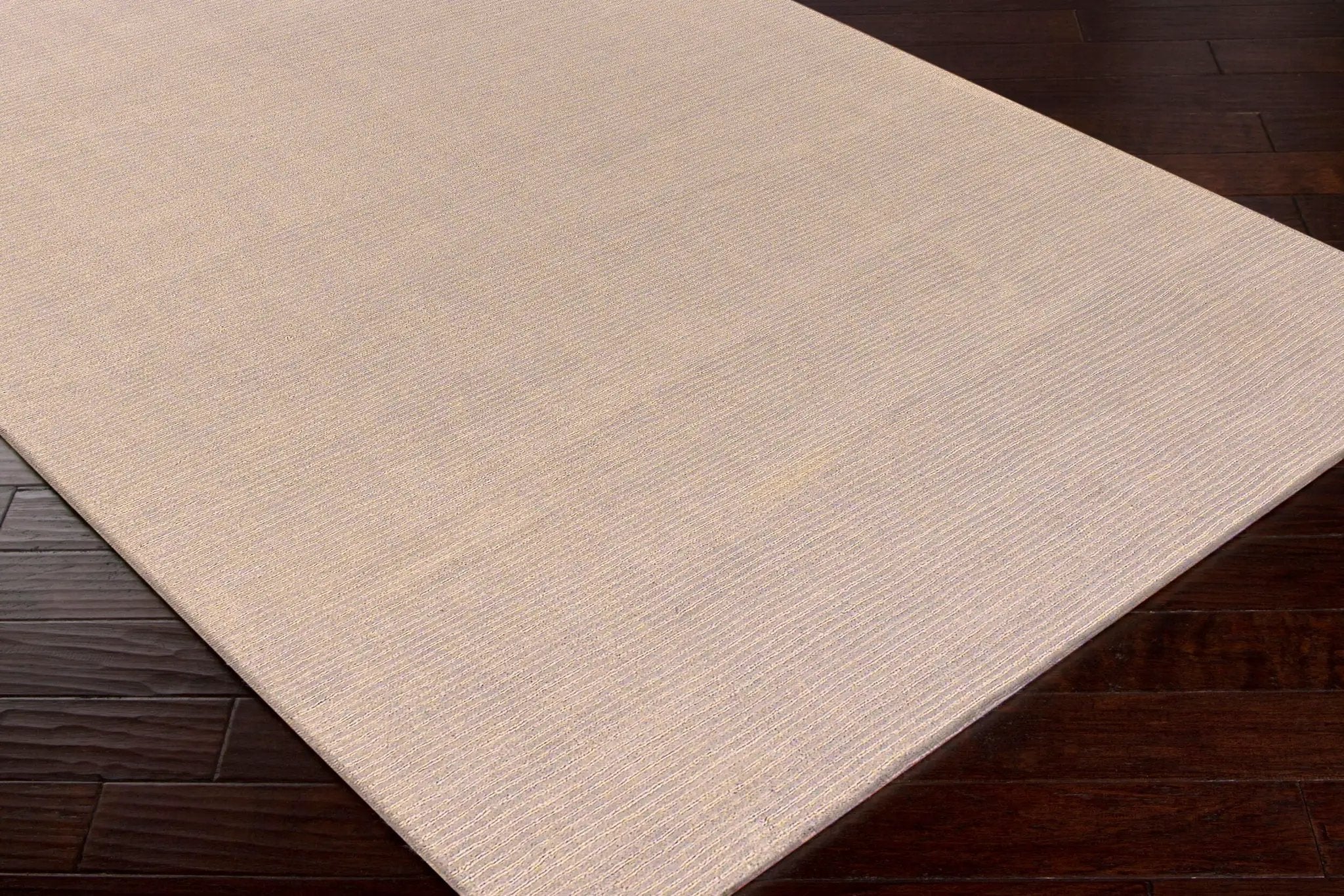 Livabliss Mystique M-335 Tan hand-loomed wool area rug with textured pile on dark hardwood floor, ideal for modern interiors.