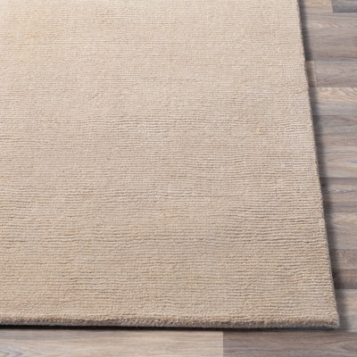 Livabliss Mystique M-335 Tan hand-loomed wool area rug with high-low pile texture on wood floor. Durable neutral design for modern interiors and steady foot traffic.