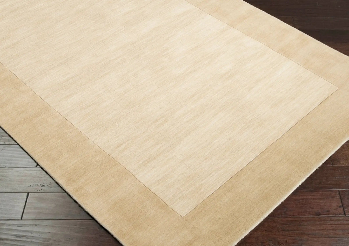 Livabliss Mystique M-344 Beige area rug with hand-loomed wool texture and contrasting border, ideal for modern minimalist living spaces.