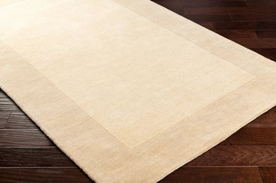 Livabliss Mystique M-348 Cream hand-loomed wool area rug with structured high-low pile and border, laid over dark hardwood flooring for contemporary interiors.