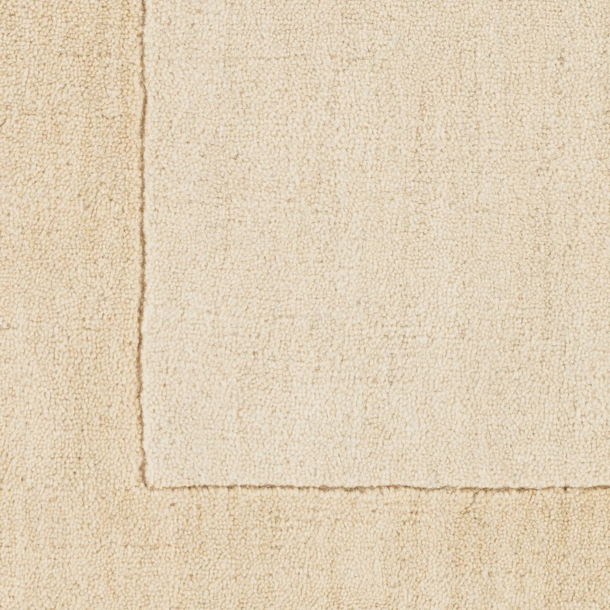 Livabliss Mystique M-5324 area rug featuring a textured wheat tone, high-low pile, and hand-loomed craftsmanship using 100% wool, complete with a border detail, perfect for contemporary rooms.