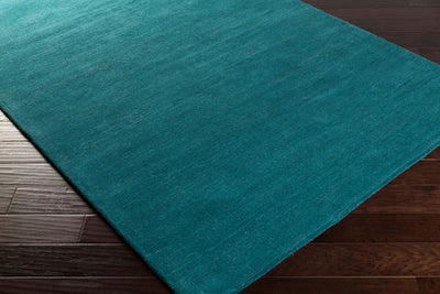Livabliss Mystique M-5330 Deep teal hand-loomed wool area rug with contemporary high/low texture on dark hardwood flooring.