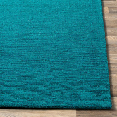 Livabliss Mystique M-5330 Deep teal hand-loomed wool area rug with contemporary high-low texture resting on light wood flooring.