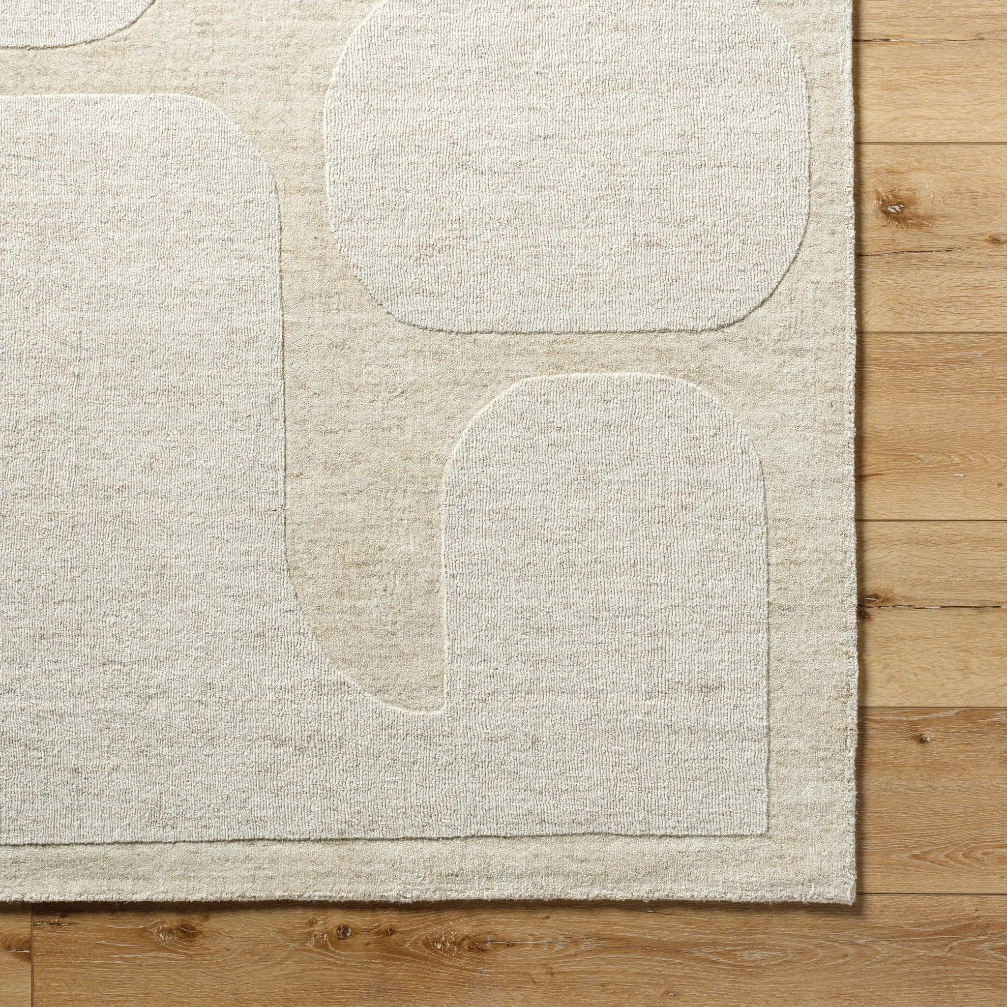 Livabliss Mystique M-5476 beige area rug featuring abstract raised shapes, hand-loomed wool texture, and durable medium pile on wood flooring.