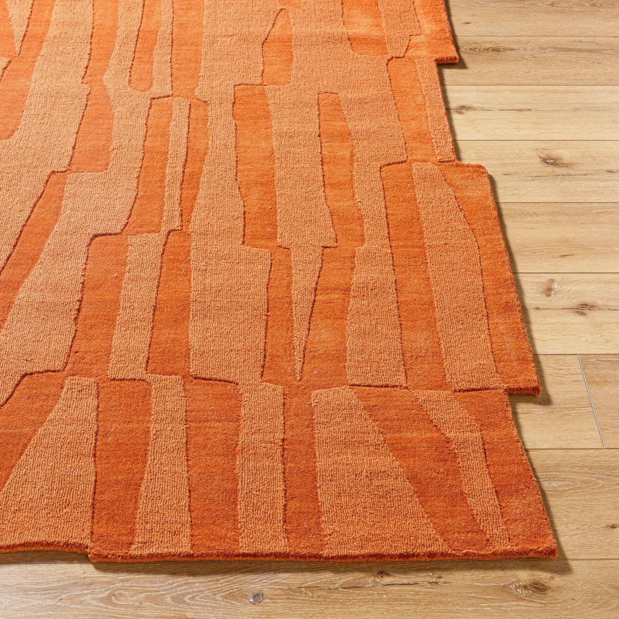 Hand-loomed Livabliss Mystique M-5488 burnt sienna wool area rug featuring abstract geometric blocks and textured medium pile on light wood flooring.