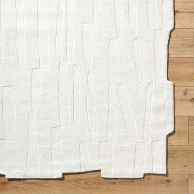 Livabliss Mystique M-5489 Ivory hand-loomed wool area rug with abstract textured pattern and irregular edge on light wood flooring.