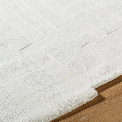 Livabliss Mystique M-5489 Ivory hand-loomed wool area rug with textured geometric pattern and medium pile resting on hardwood flooring.