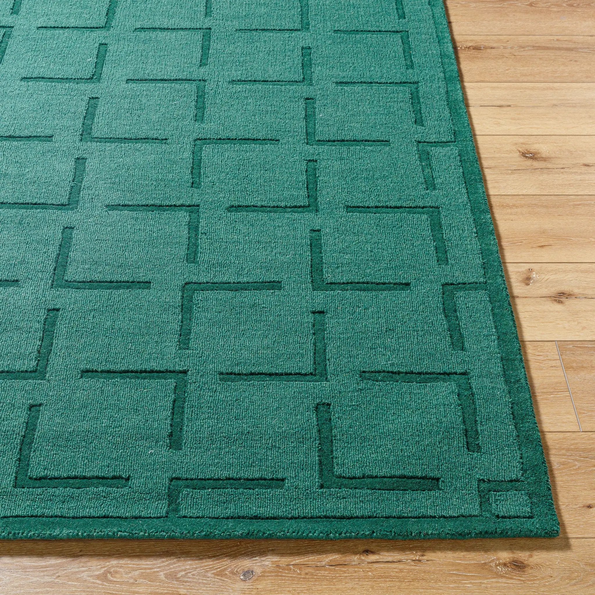 Livabliss Hand Loomed Mystique M-5490 Emerald Green area rug with embossed geometric pattern on natural wool, featuring consistent texture and contemporary design on wood flooring.