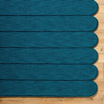 Livabliss Hand Loomed Mystique M-5491 Teal wool area rug with medium-pile texture and distinctive scalloped edge resting on hardwood flooring.