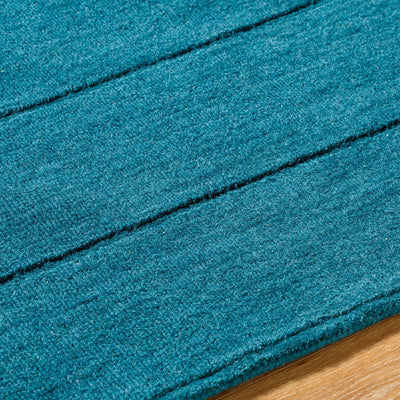 Livabliss Hand Loomed Mystique M-5491 Teal wool area rug with medium-pile texture and distinctive dark horizontal lines resting on hardwood flooring.