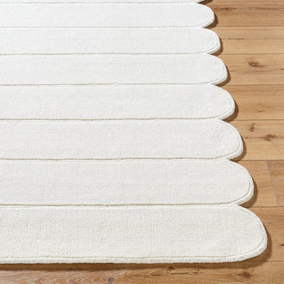 Livabliss Mystique M-5492 Ivory hand-loomed wool area rug featuring a balanced medium pile and decorative scalloped edge on hardwood flooring.