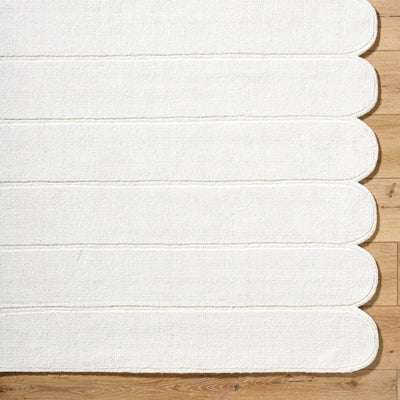 Livabliss Mystique M-5492 Ivory hand-loomed wool area rug with striped texture and scalloped edge lying on light wood flooring.