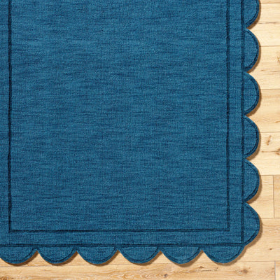 Livabliss Mystique M-5493 Indigo wool area rug with scalloped edges and border, showcasing handcrafted texture on hardwood floor.
