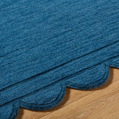 Livabliss Mystique M-5493 Indigo wool hand loomed area rug with scalloped edge and scalloped border resting on hardwood flooring.