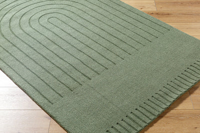 Livabliss Mystique M-5495 Sage green wool area rug with embossed concentric arch pattern and textured weave resting on light hardwood flooring.