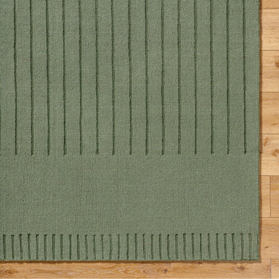 Livabliss Mystique M-5495 textured sage green hand-loomed area rug with vertical striped weave pattern on light hardwood floor.