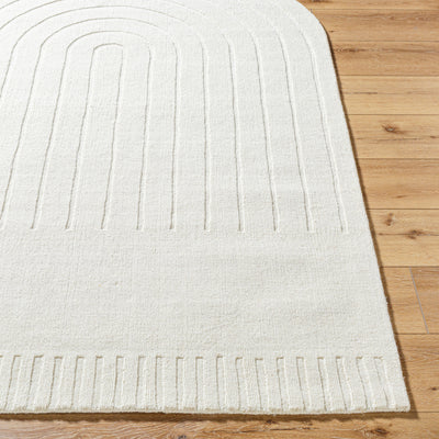 Handmade Livabliss Mystique M-5496 ivory wool area rug featuring raised arch patterns and textured border, resting on light wood flooring for a refined neutral look.