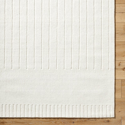 Livabliss Mystique M-5496 Ivory handmade wool area rug with textured vertical stripes and ribbed border resting on light wood flooring.