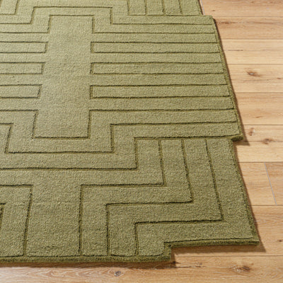 Livabliss Mystique M-5497 Olive green wool area rug with raised geometric pattern and hand-loomed texture on light wood flooring.