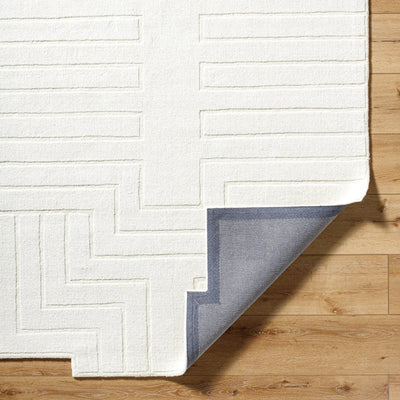 Livabliss Mystique M-5498 Ivory hand-loomed wool area rug with embossed geometric lines and grey backing corner on wood floor.