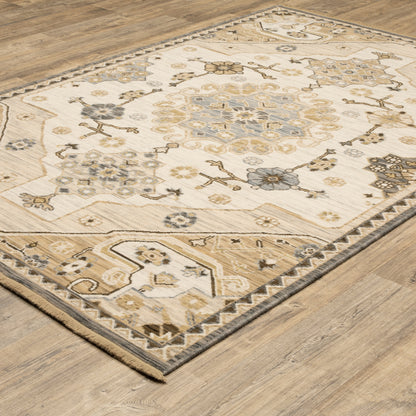 Acacia ACA03 Tan/Grey traditional area rug with earthy tan, grey, brown, gold, blue, clay, and green tones and cotton fringe.