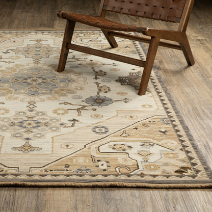 Acacia ACA03 Tan/Grey traditional area rug with earthy tan, grey, brown, gold, blue, clay, and green tones and cotton fringe.