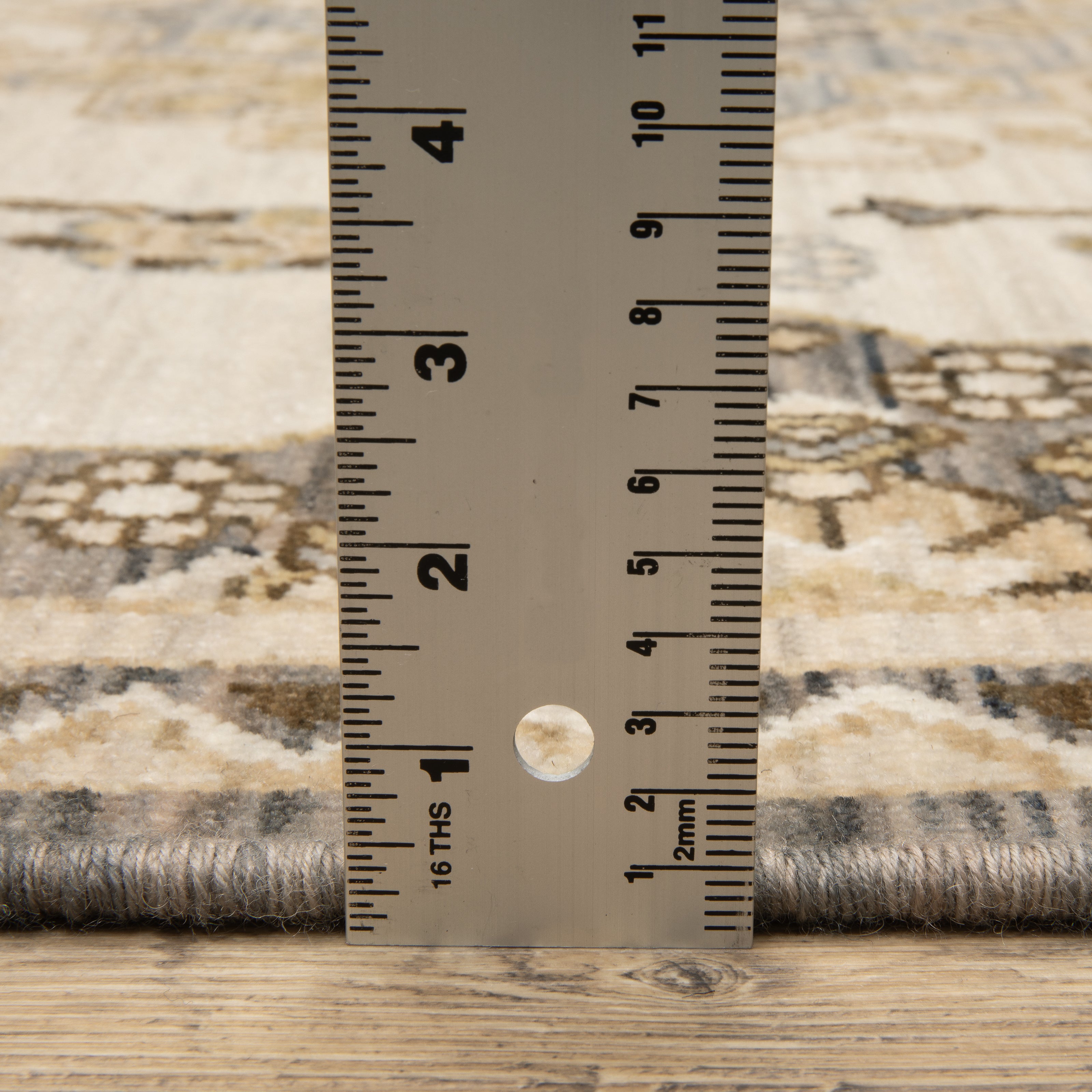 Acacia ACA03 Tan/Grey traditional area rug with earthy tan, grey, brown, gold, blue, clay, and green tones and cotton fringe.