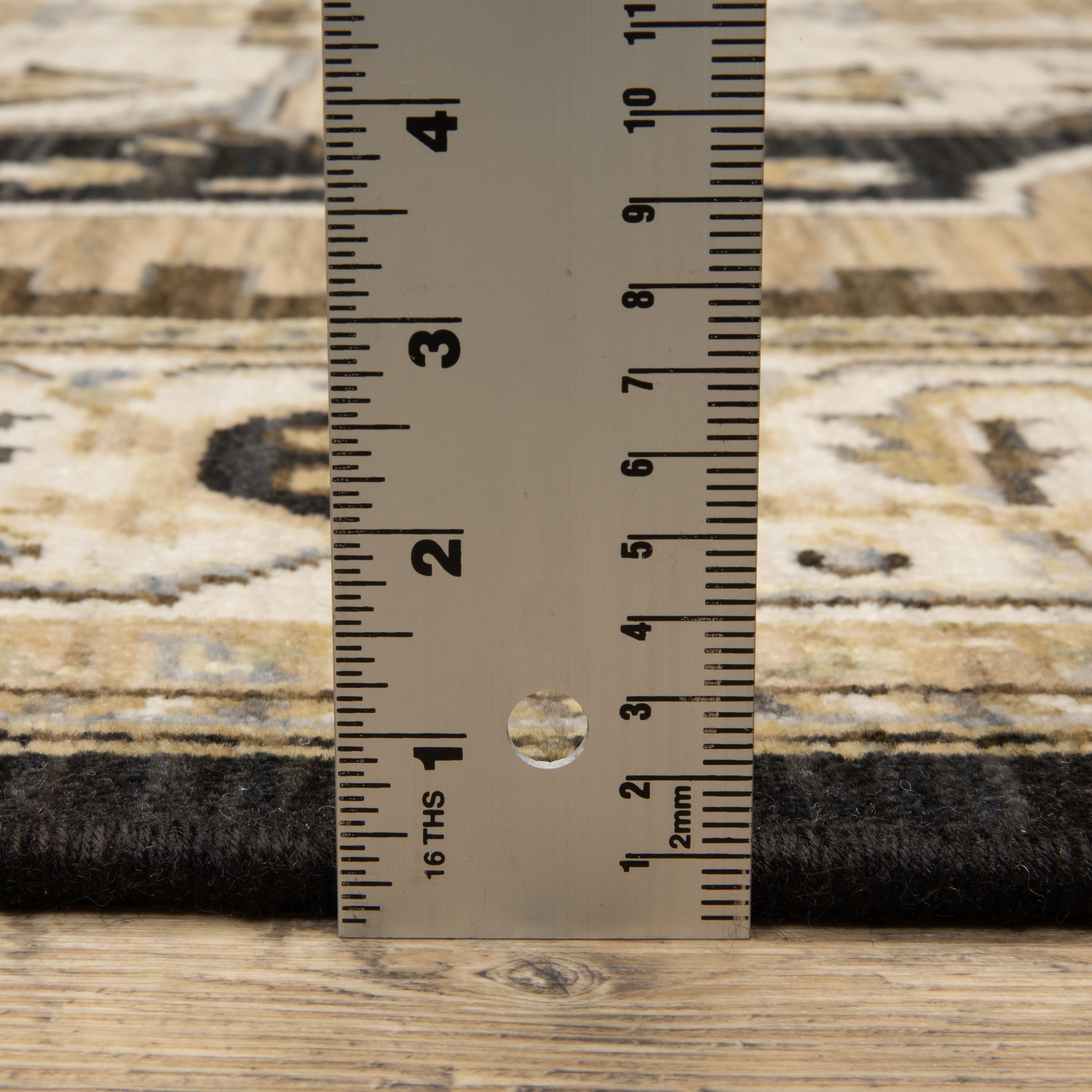 Acacia ACA08 Tan/Black traditional area rug with bold black contrast, warm tan ground, earthy accent colors, and incorporated cotton fringe.