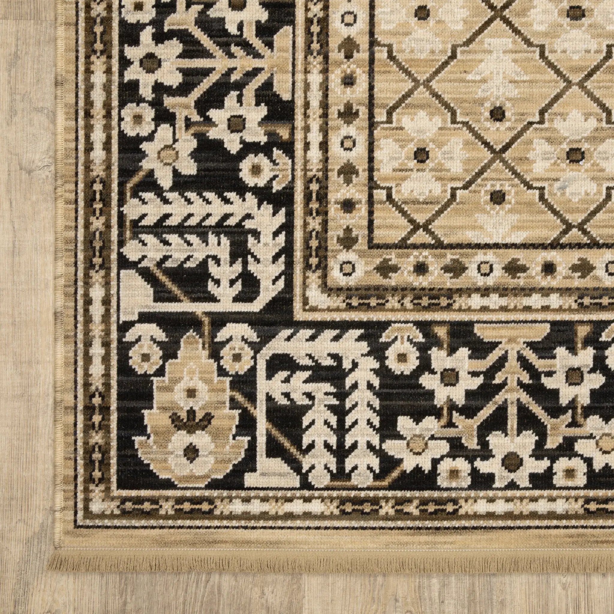 Acacia ACA12 Tan/Charcoal area rug with warm tan ground, charcoal contrast, traditional pattern detail, earthy accents, and cotton fringe.