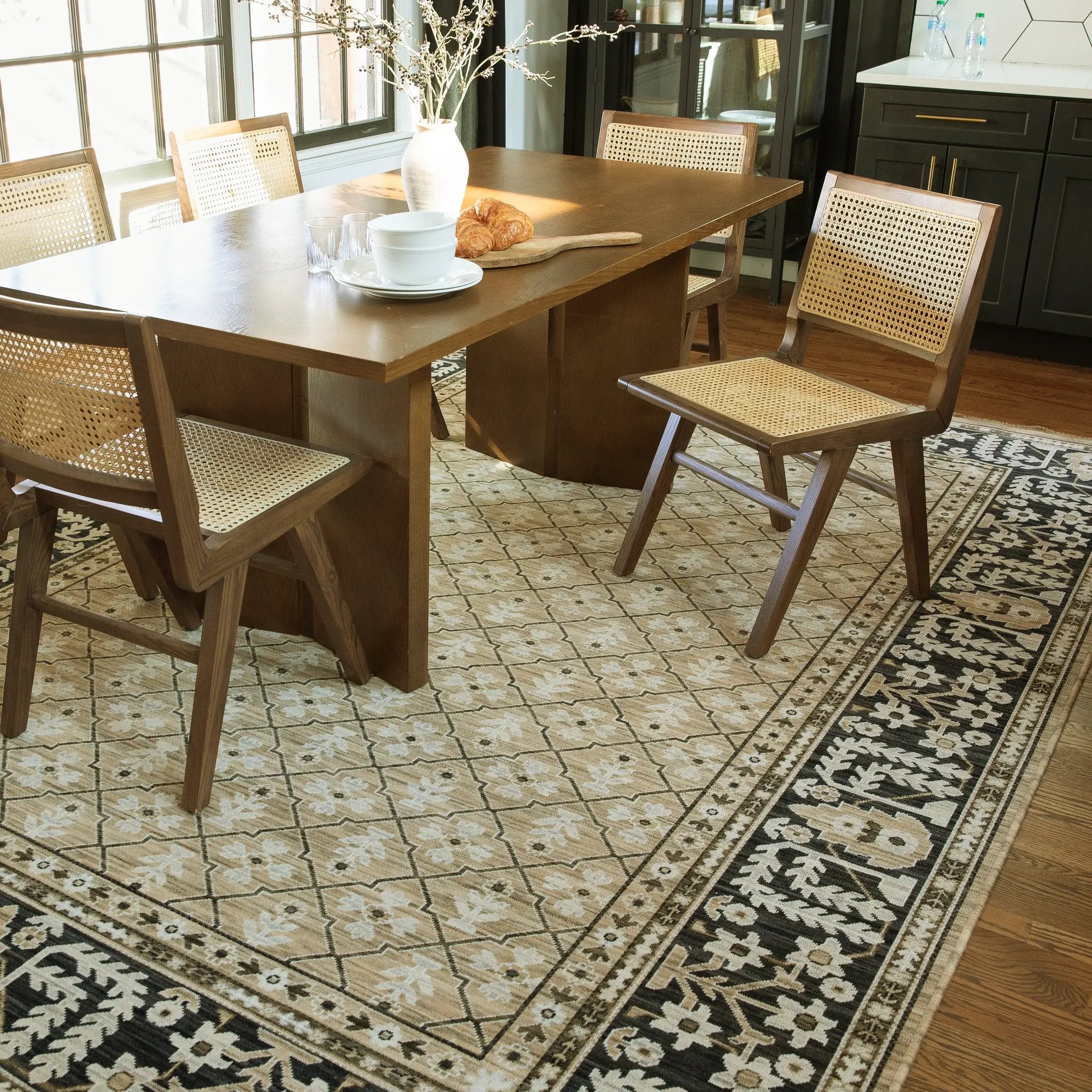 Acacia ACA12 Tan/Charcoal area rug with warm tan ground, charcoal contrast, traditional pattern detail, earthy accents, and cotton fringe.