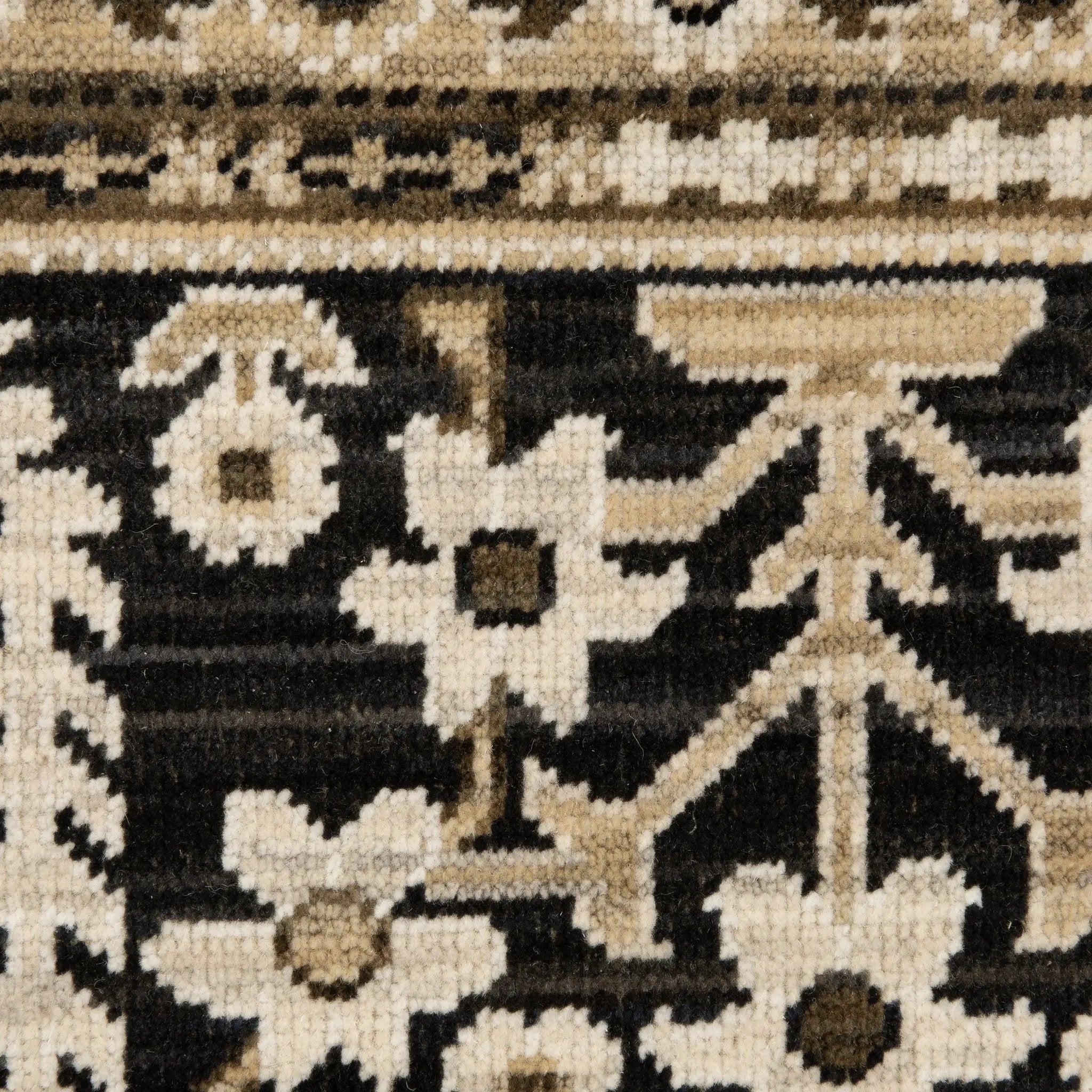 Acacia ACA12 Tan/Charcoal area rug with warm tan ground, charcoal contrast, traditional pattern detail, earthy accents, and cotton fringe.
