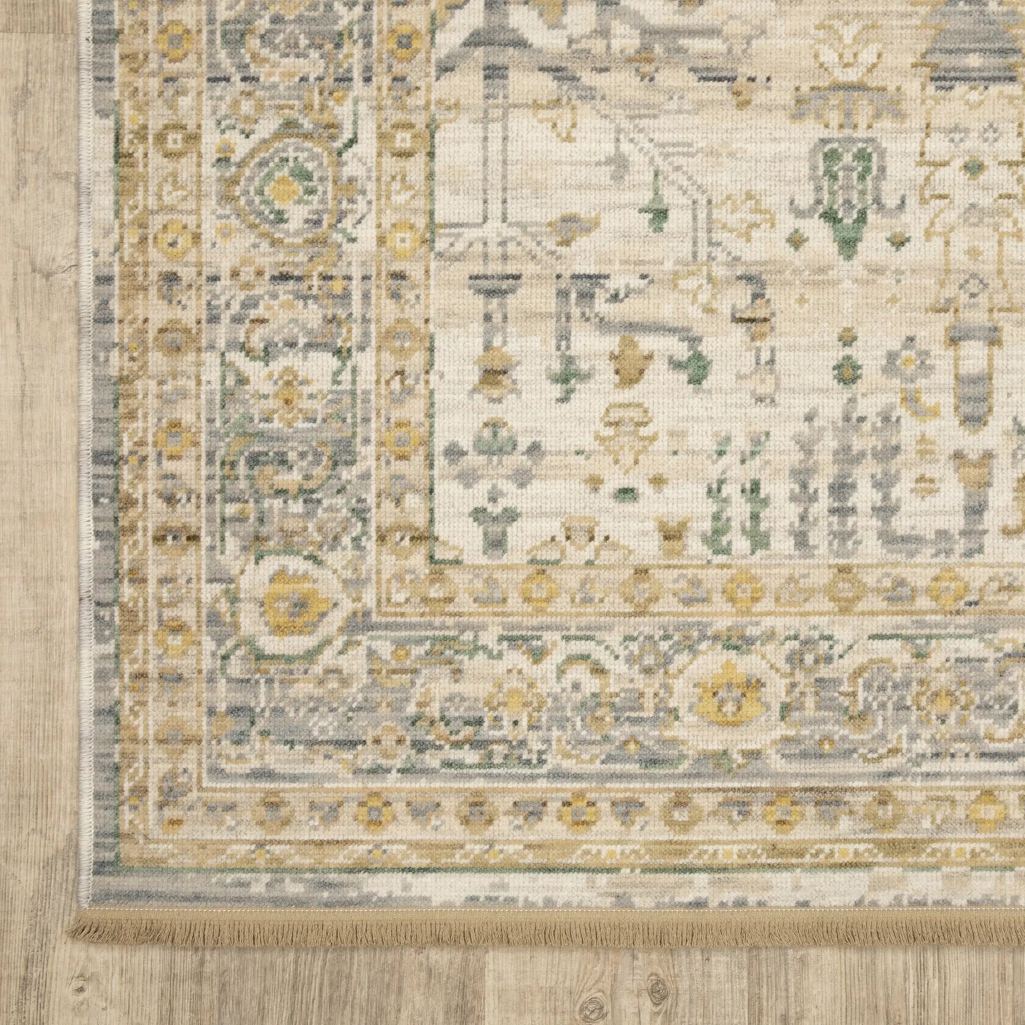 Acacia ACA14 Beige/Green nature-inspired traditional area rug with soft beige and green palette, warm accent colors, and cotton fringe.