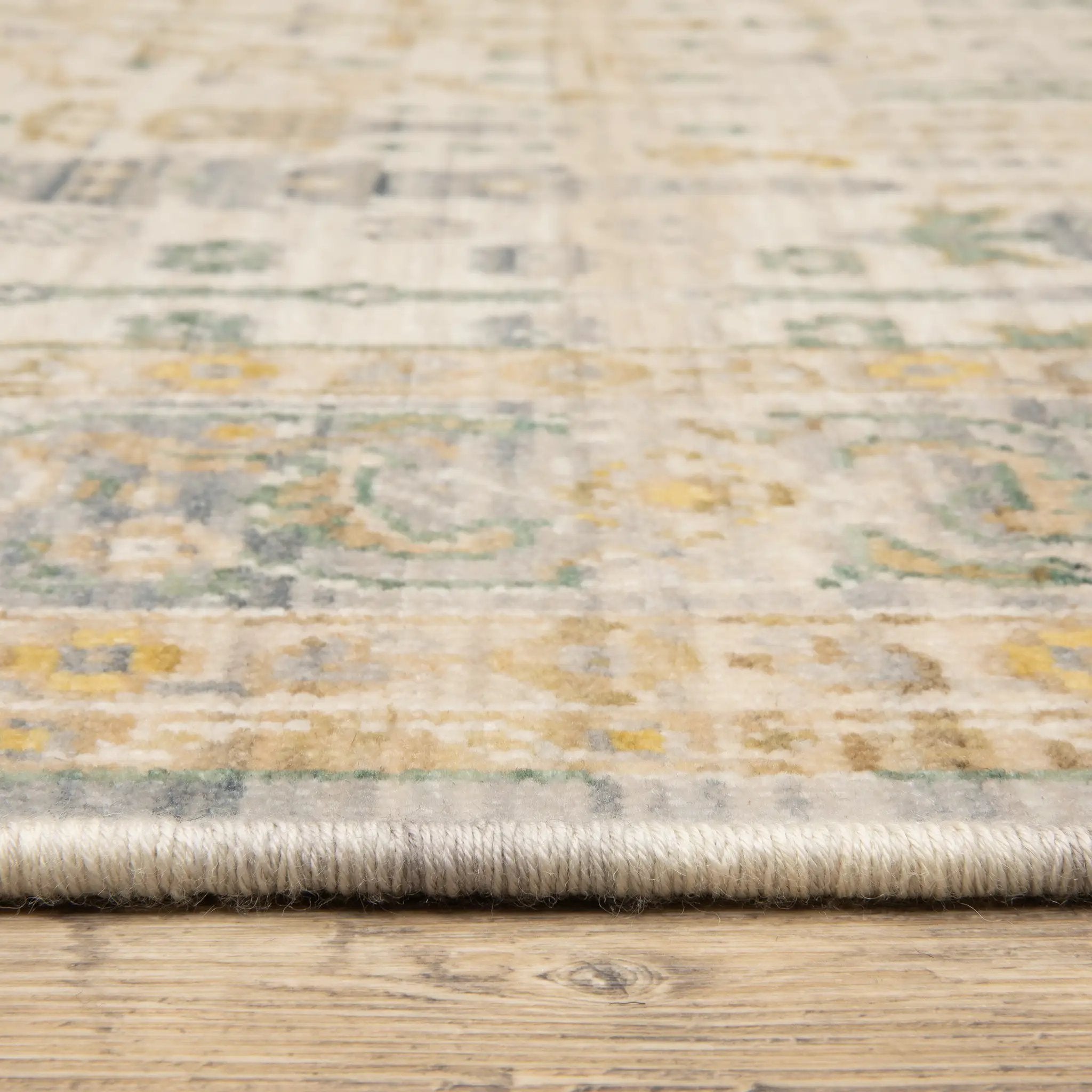 Acacia ACA14 Beige/Green nature-inspired traditional area rug with soft beige and green palette, warm accent colors, and cotton fringe.