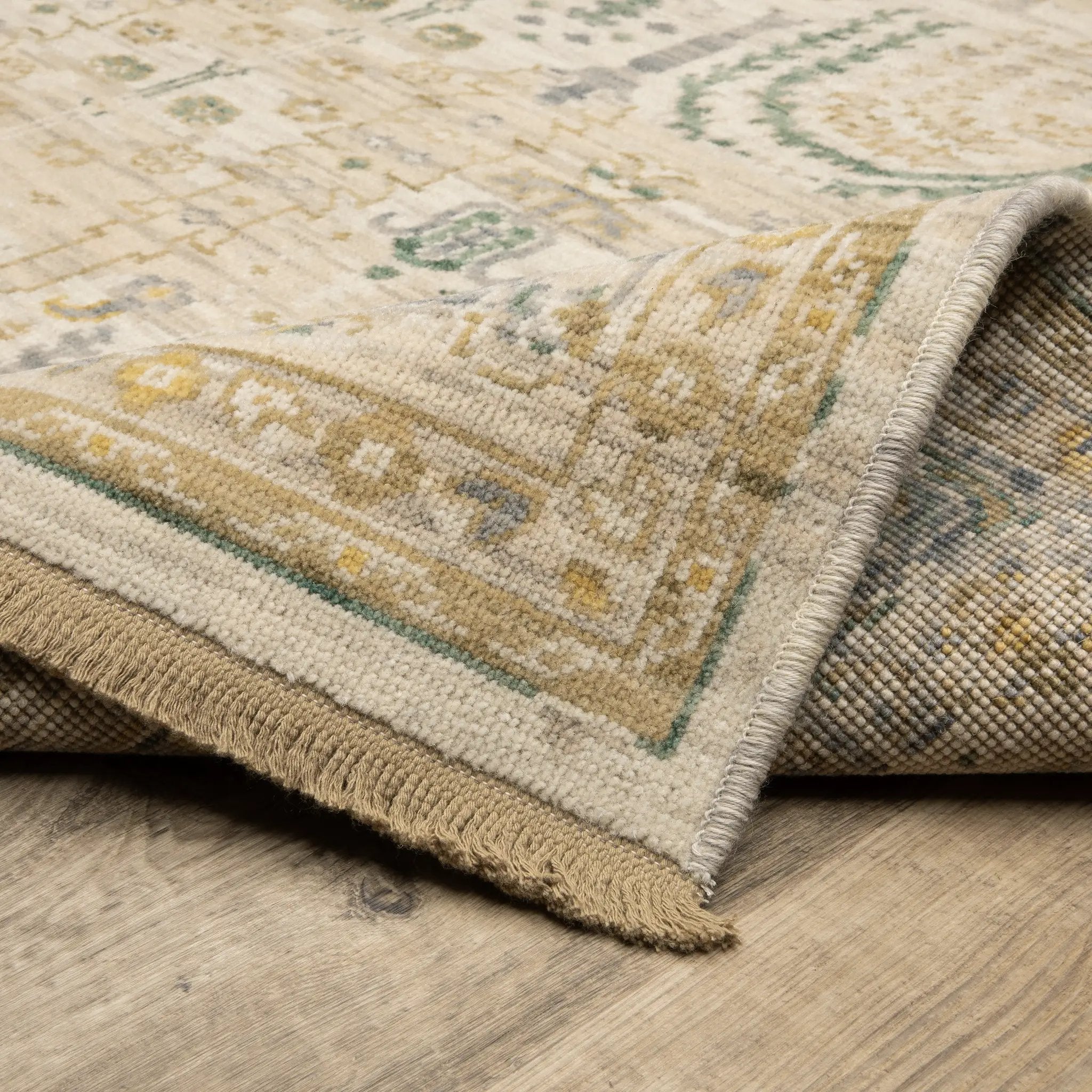 Acacia ACA14 Beige/Green nature-inspired traditional area rug with soft beige and green palette, warm accent colors, and cotton fringe.