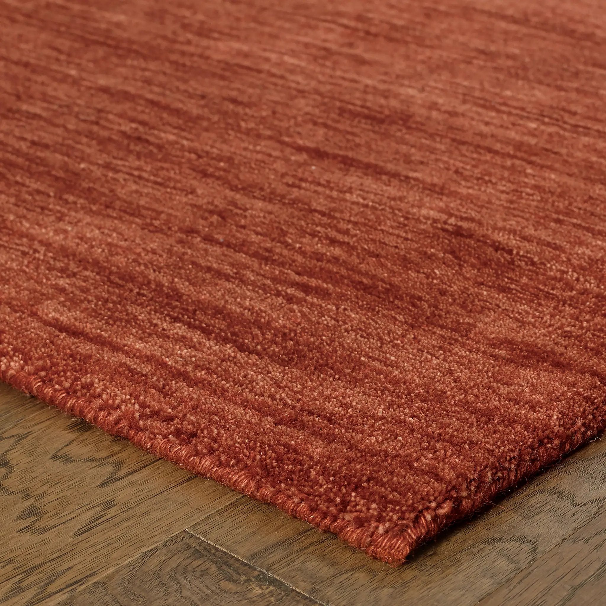 Aniston 27103 Rust Area Rug, rust solid wool area rug with heathered texture and warm handwoven surface.