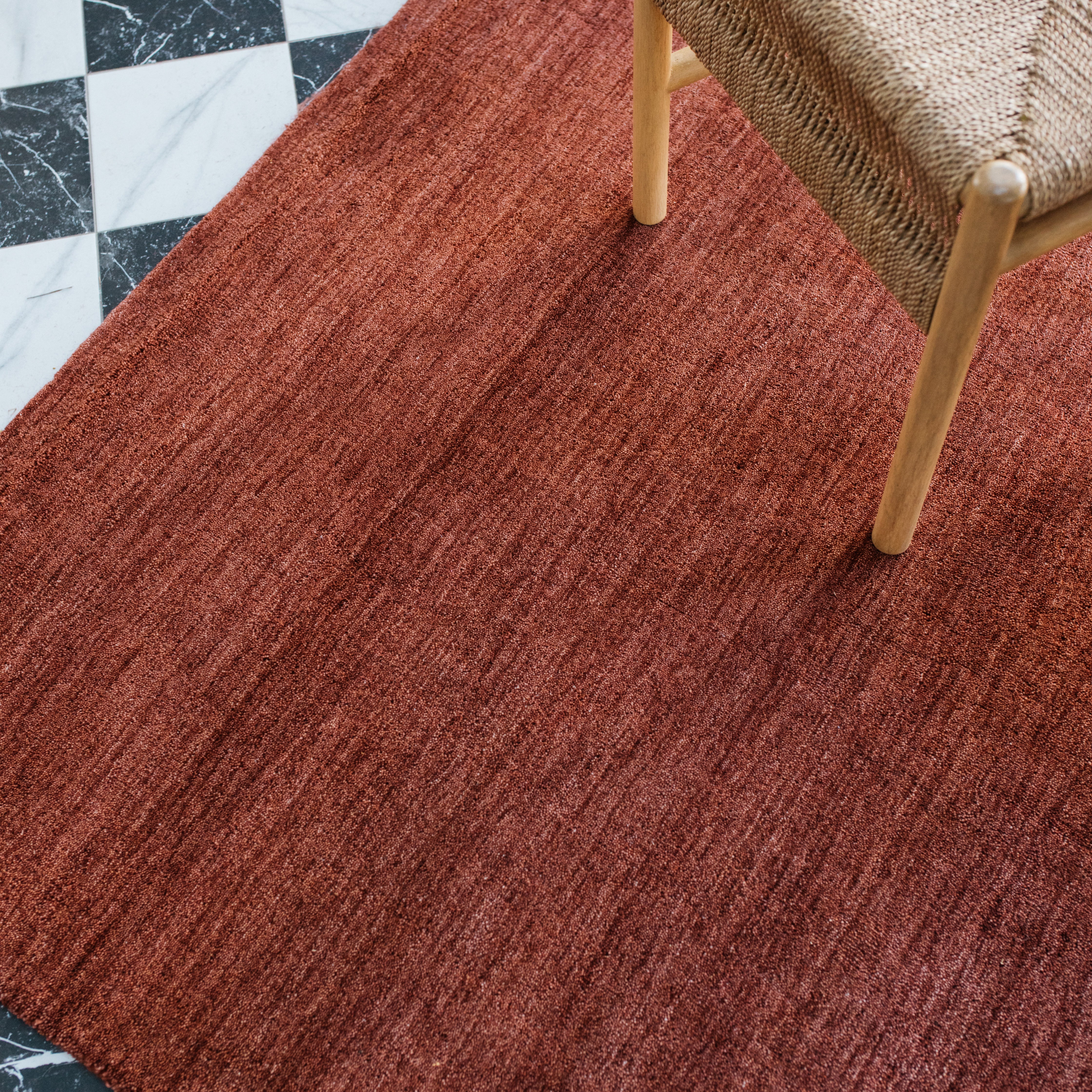 Aniston 27103 Rust Area Rug, rust solid wool area rug with heathered texture and warm handwoven surface.