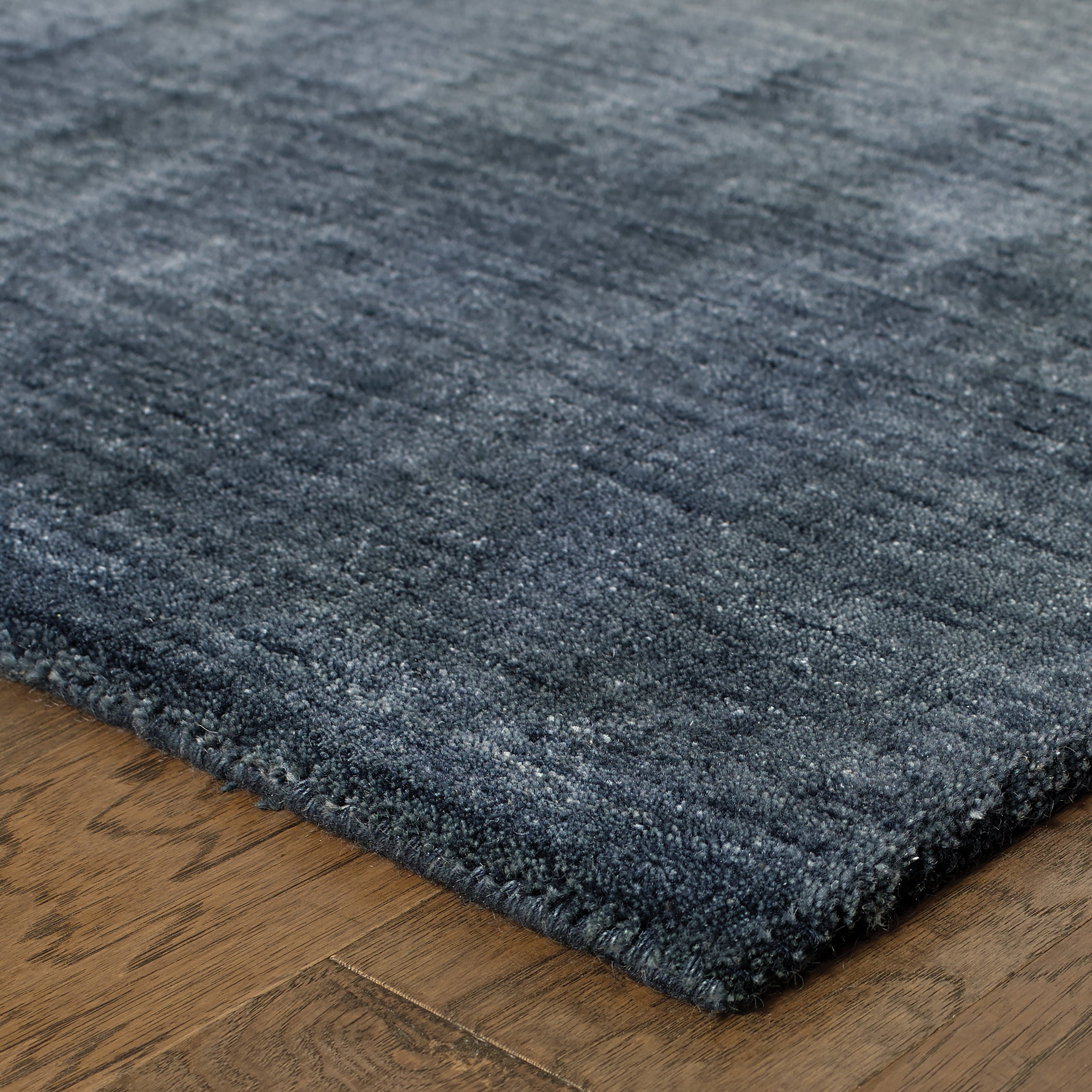 Aniston 27106 Navy Area Rug, navy solid wool area rug with heathered tonal variation and handwoven texture.