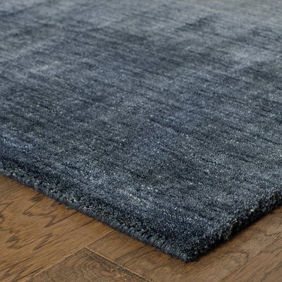 Aniston 27106 Navy Area Rug, navy solid wool area rug with heathered tonal variation and handwoven texture.