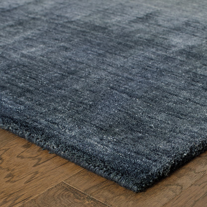 Aniston 27106 Navy Area Rug, navy solid wool area rug with heathered tonal variation and handwoven texture.