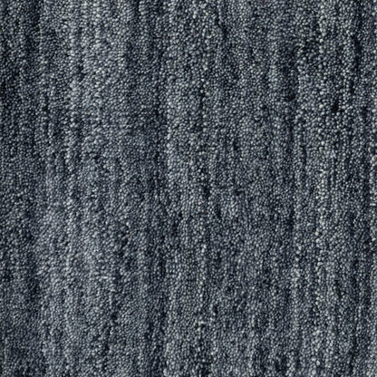 Aniston 27106 Navy Area Rug, navy solid wool area rug with heathered tonal variation and handwoven texture.