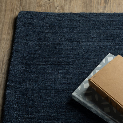 Aniston II 27119 Navy Area Rug, navy solid wool area rug with heathered texture and plush hand-tufted surface.