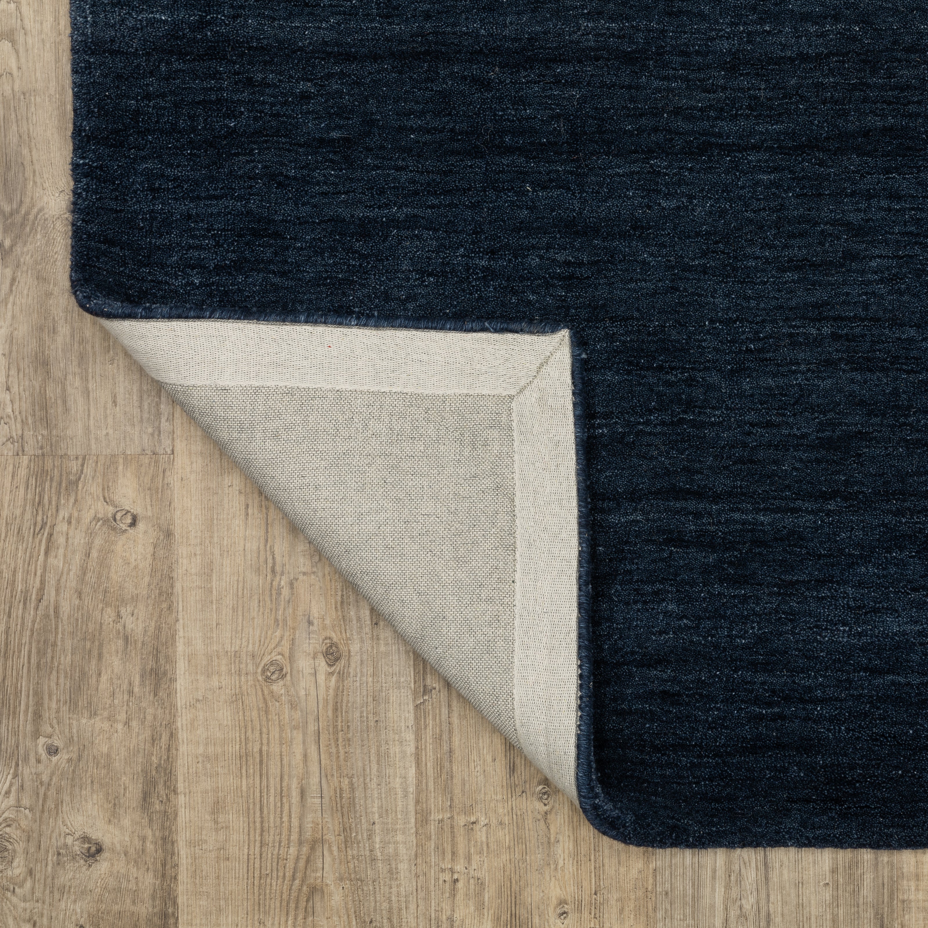 Aniston II 27119 Navy Area Rug, navy solid wool area rug with heathered texture and plush hand-tufted surface.