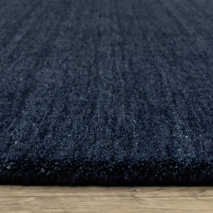 Aniston II 27119 Navy Area Rug, navy solid wool area rug with heathered texture and plush hand-tufted surface.