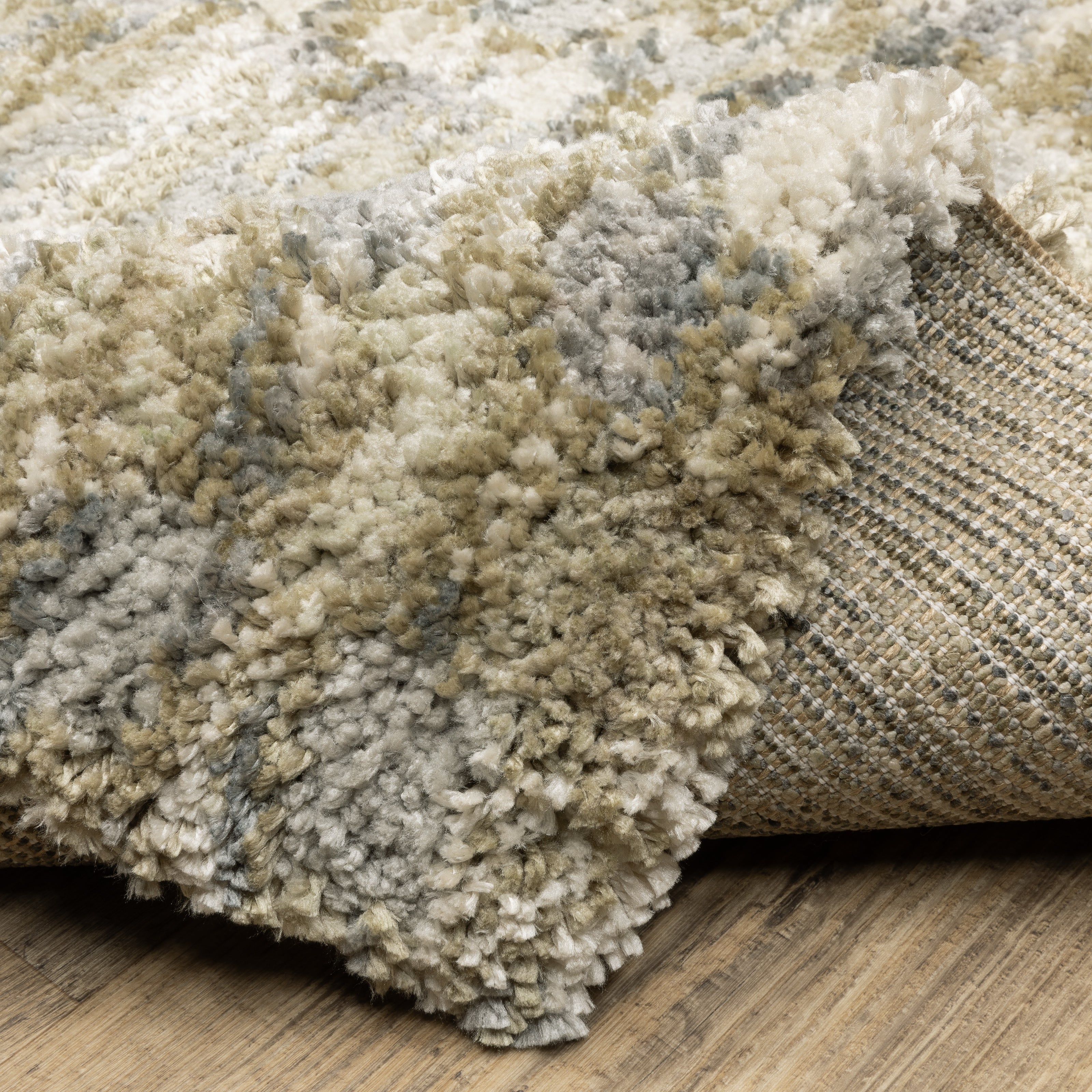 Oriental Weavers Aspen 3052A plush shag rug featuring abstract pattern in gold/ grey tones