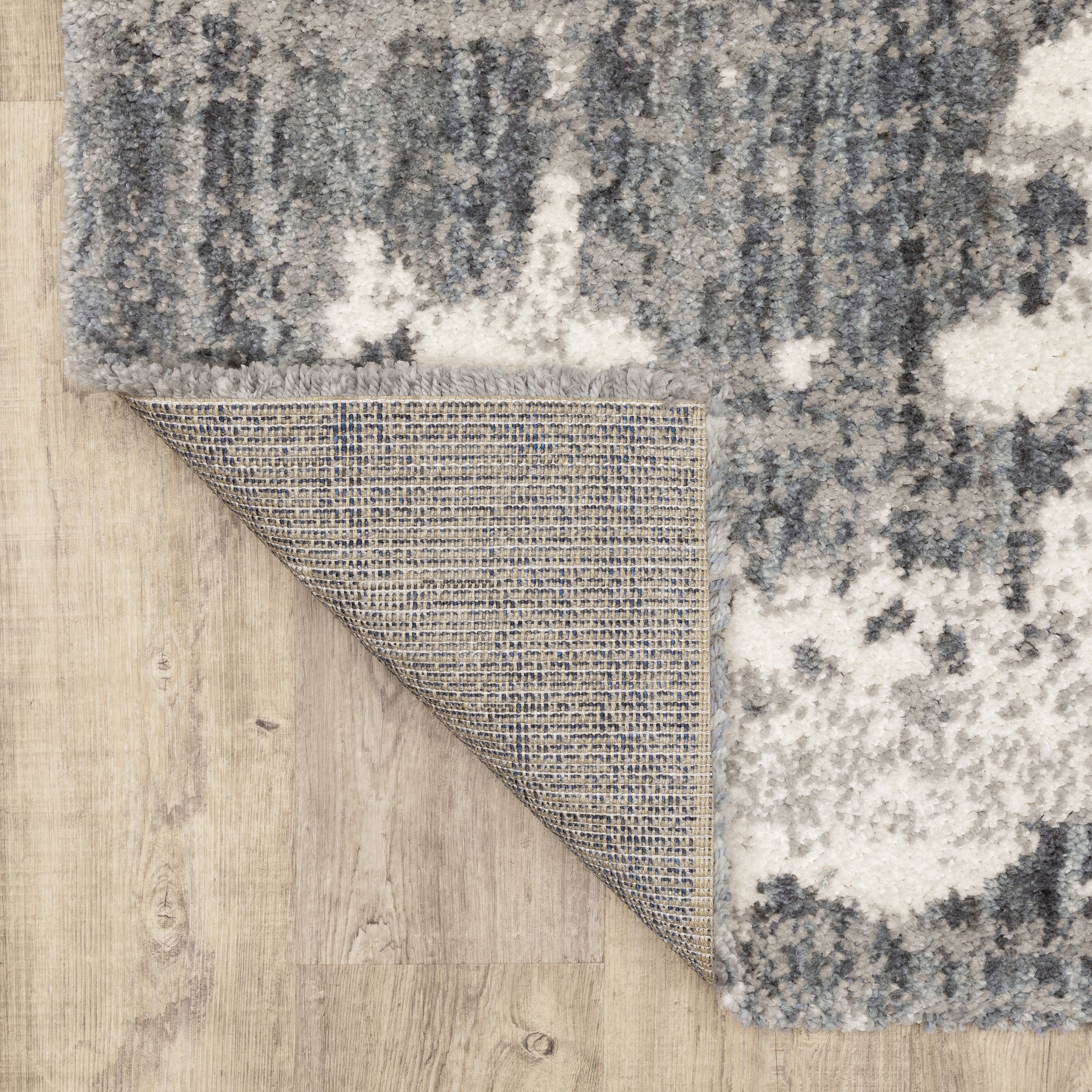 Oriental Weavers Aspen 003H9 plush shag rug featuring abstract pattern in grey/ ivory tones