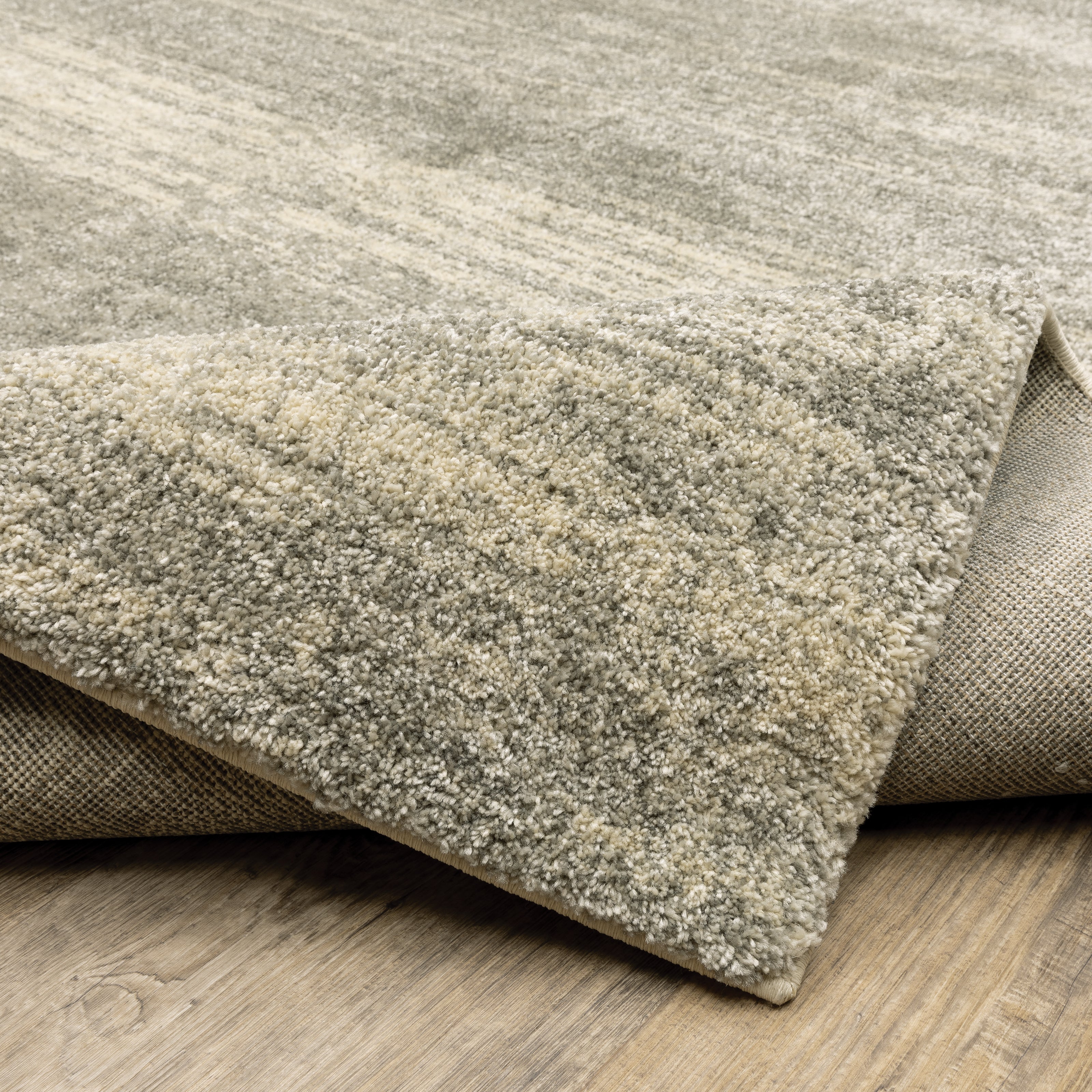 Oriental Weavers Astor 5572E plush modern rug featuring abstract pattern in grey/ beige tones
