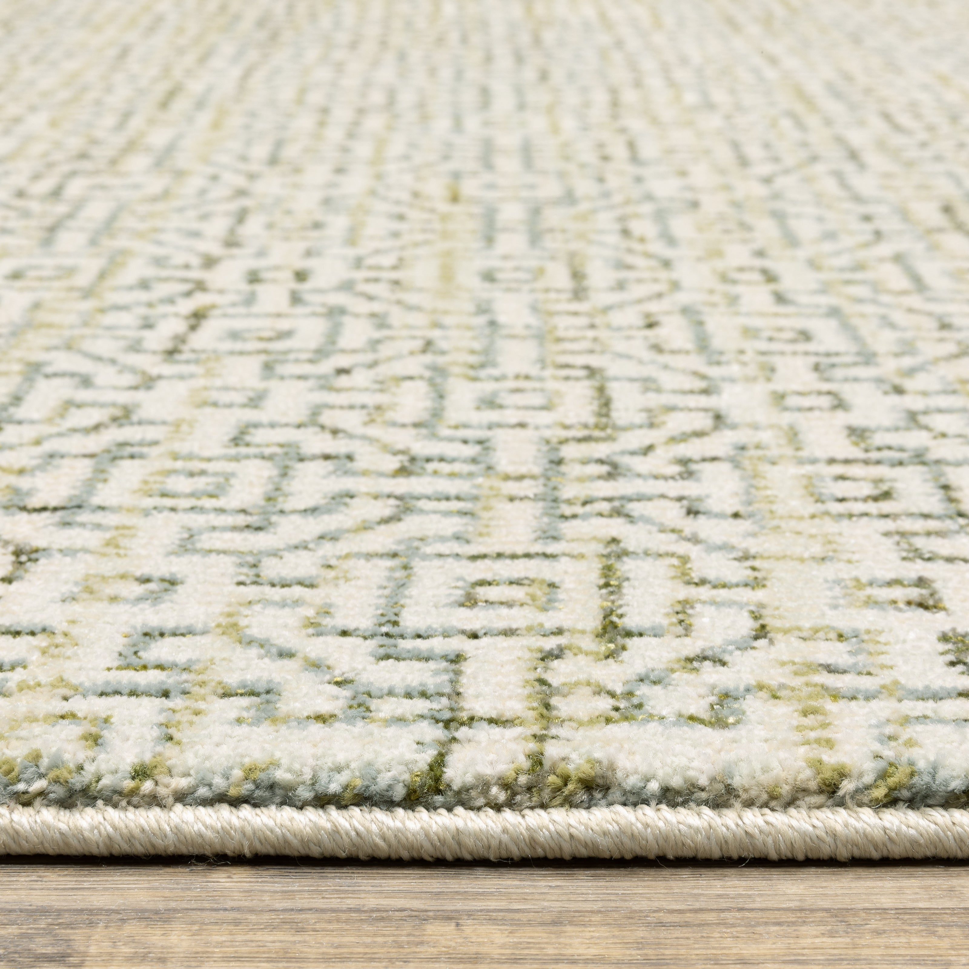 Oriental Weavers Atlas 3721K textured area rug featuring textured design in ivory/ green tones