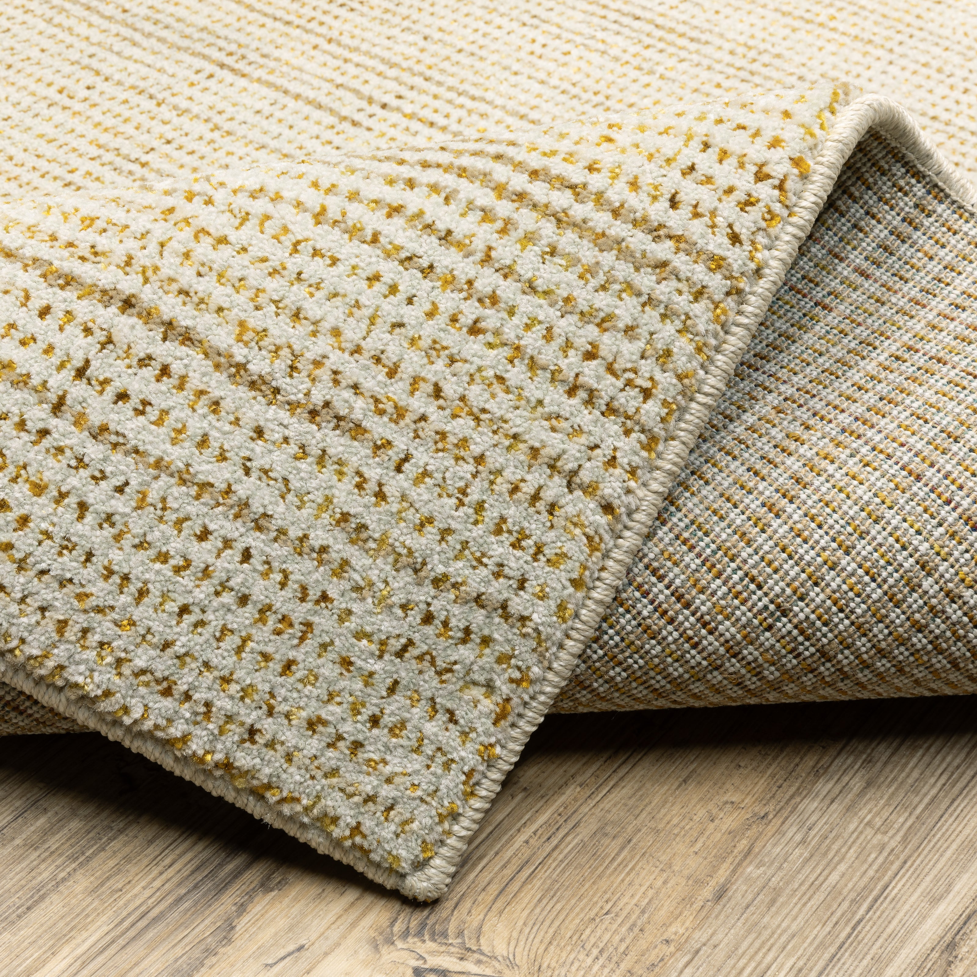 Oriental Weavers Atlas 3723N textured area rug featuring textured design in ivory/ gold tones